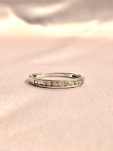Load image into Gallery viewer, Vintage 18k white gold half eternity band with 11 diamonds in a channel setting. This minimalist ring comes London c 1969. Excellent vintage condition Size: 7.5 Weight: 2.2 grams Band: 2.6 mm (front), 1.7 mm (back) Diamond: 11 diamonds approx. 0.2ctw Hallmarks: crown for gold, 750 for 18k, leopard for London
